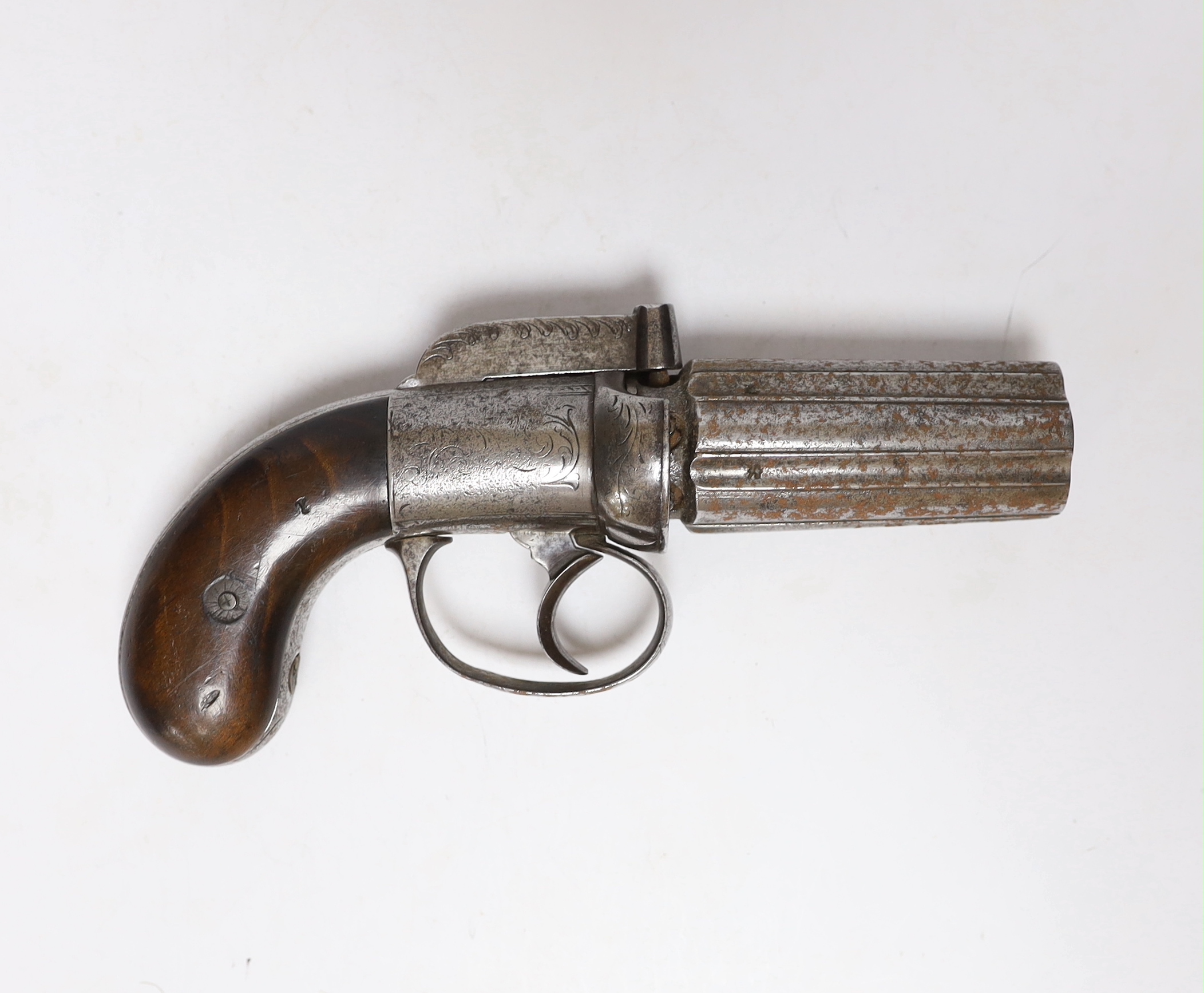 A mid-19th century six shot self-cocking percussion pepper box revolver, with foliate engraved frame, fluted barrels and two piece walnut grips, barrel 7.5cm